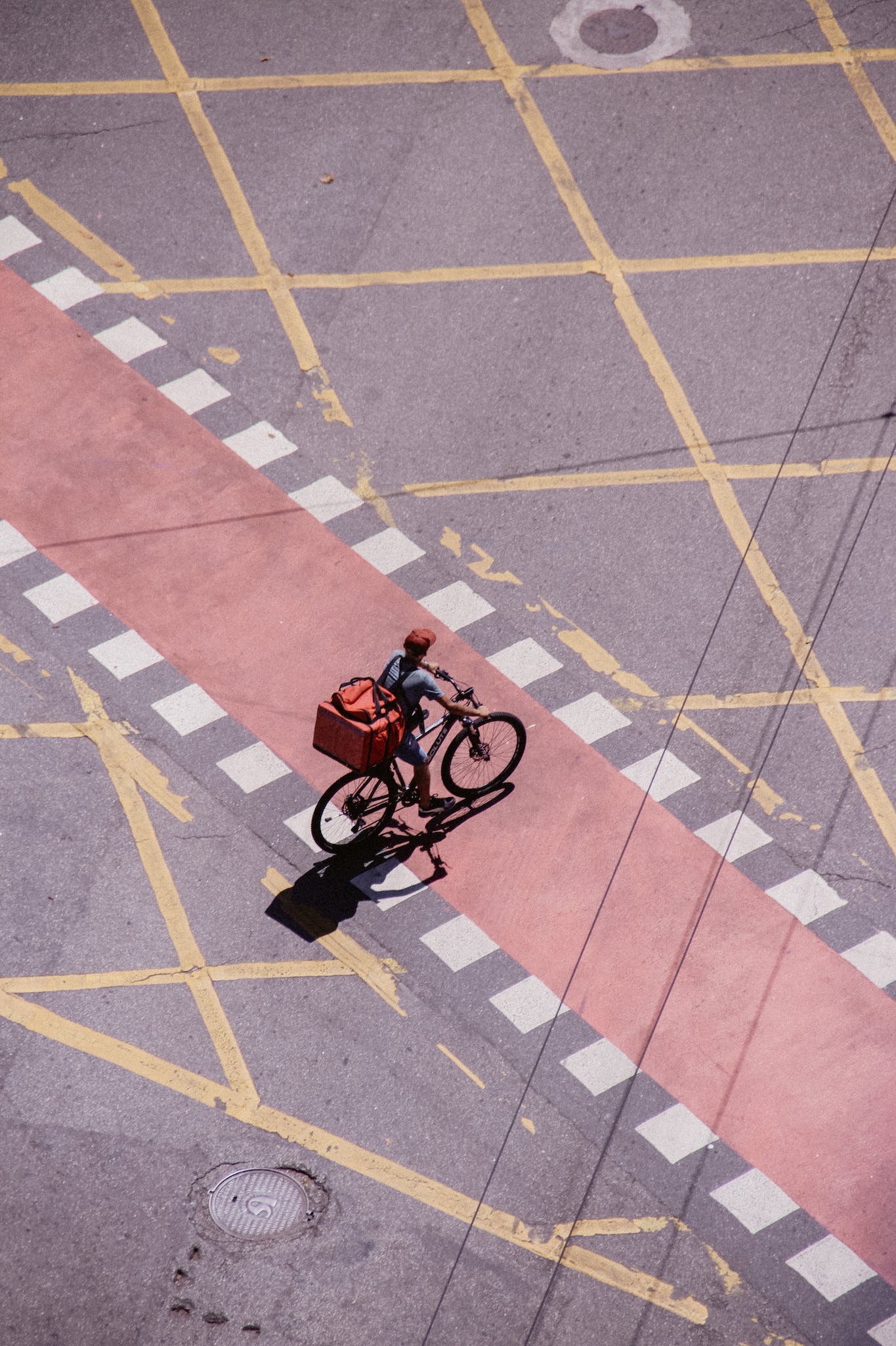 Deliveryman with Package Riding Bike on Road